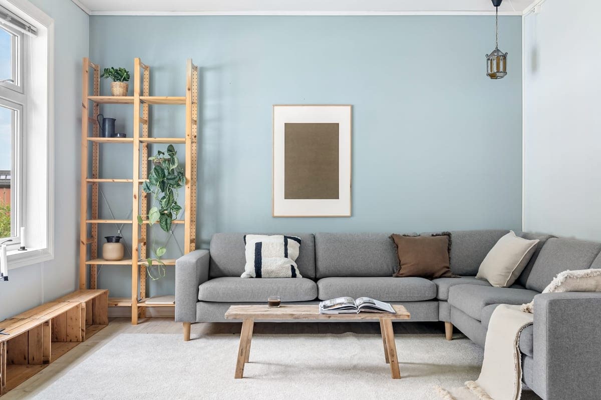 A calm, tidy living room with a smart speaker and warm daylight